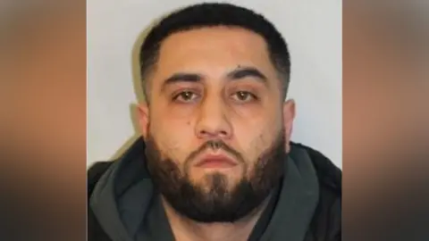 Met Police A bearded man with a neutral expression