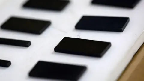Rows of rectangular rare earth magnets in a factory in Japan