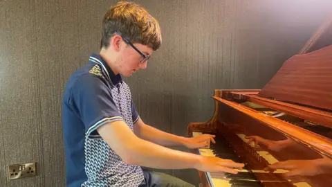 Cory McReynolds playing the piano