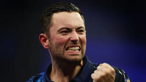 Luke Humphries clenches a fist in celebration