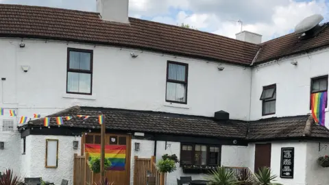 Gregory Maskalick Rainbow flags and bunting put up in June during Pride month