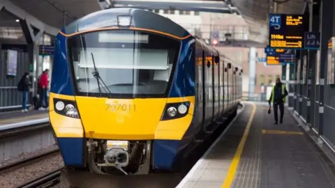 A blue Southeastern train with a yellow front leaves a platform at London Bridge station, travelling to London Cannon Street.