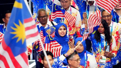 PA Media Malaysia team in red white and blue outfits
