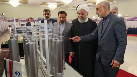 EPA Iranian President Hassan Rouhani (2R) is shown nuclear technology by Ali Akbar Salehi (R), head of Atomic Energy Organization of Iran (9 April 2019)