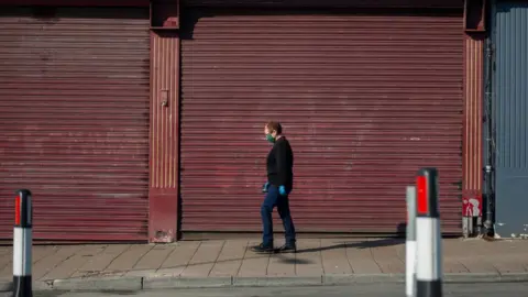 Getty Images Woman walking through Cardiff street