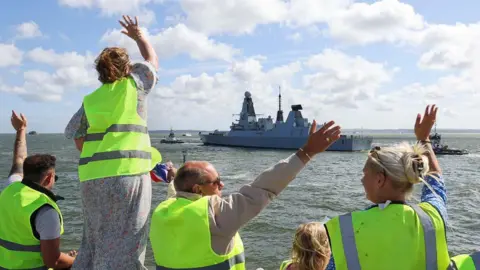 People waving off HMS Duncan as it sets off from Portsmouth