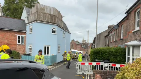 LDRS Gas and electrical workers at the affected area. There are barriers near one property at 2 Holloway Road & Fordington High Street Junction.