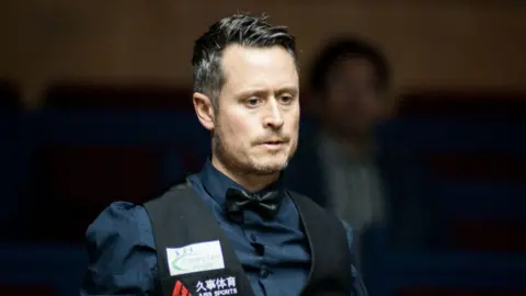 Alfie Burden wearing a waistcoat and shirt