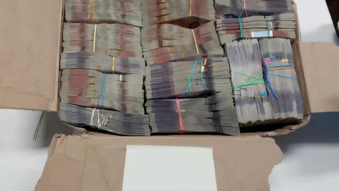 West Midlands Police Cash in a cardboard box