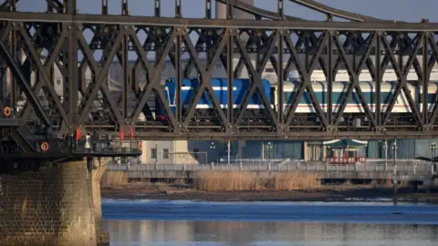 A scheduled passenger train arrives from North Korea on the Sino-Korean Friendship Bridge to the Chinese border city of Dandong, in China's northeast Liaoning province on February 23, 2019