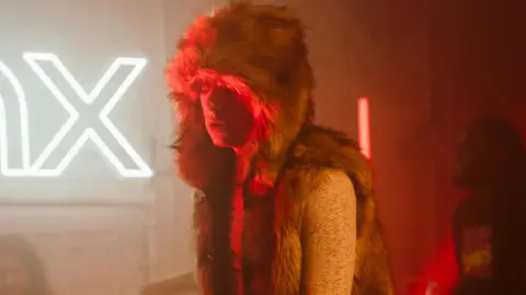 Alx Romance A man in a furry jacket sings