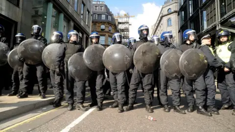 Getty Images Police holding shields at the 2009 London G20 protests