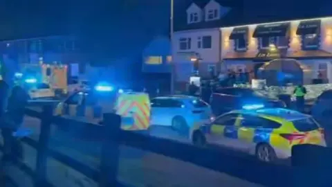 A screenshot of police cars lined up on the street 