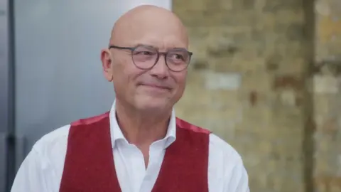 Gregg Wallace, wearing a white collared shirt and a red waistcoat