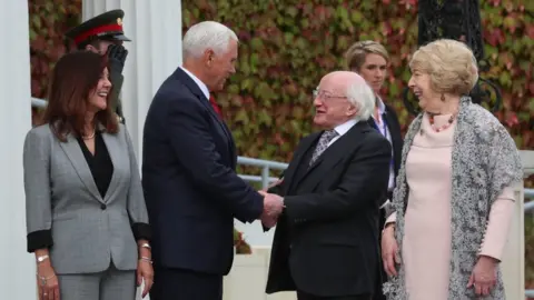 PA Mike Pence shakes hands with Irish President Michael D Higgins in the company of his wife Karen and Mr Higgins' wife Sabina