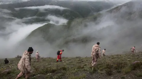 Reuters Iranian rescue teams search for the wreckage of President Ebrahim Raisi's helicopter (19 May 2024)