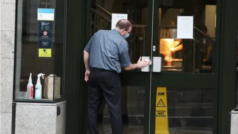 man cleaning restaurant door