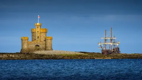 PICSBYCORRASTE The Tower of Refuge is on the left, on the right you can see the old ship in the background.