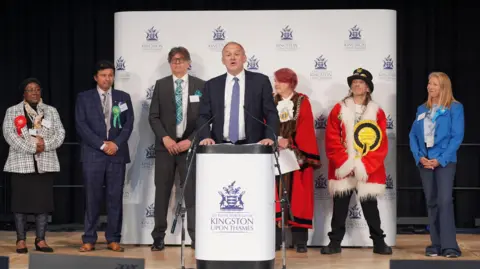 PA Media At the general election, Ed Davey making a victory speech on the podium surrounded by the other candidates