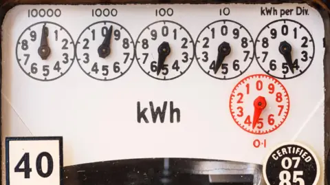 The dials of an old-style electricity meter