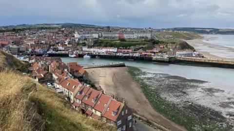 Seb Cheer/BBC A view of Whitby including the harbour with the buildings on either side 
