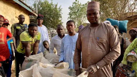 Kyla Herrmannsen/ BBC Millet seller Mukhtar Garba Intini