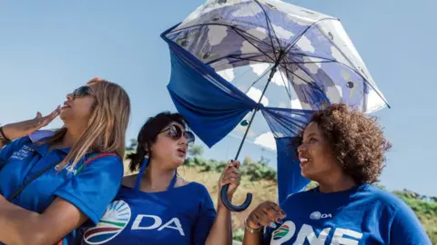 AFP Democratic Alliance members await the arrival of Mmusi Maimane on the campaign trail in Durban on 17 March 2019.