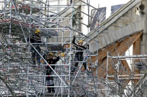 Getty Images Workers are seen restoring the Notre-Dame cathedral