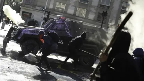 EPA Demonstrators clash with the police during a protest in Santiago, Chile, 06 June 2018