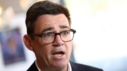 Prime Minister Andy Burnham speaks during a TV interview at The Hub cafe in Ilkeston, Derbyshire, as part of his tour of the UK.