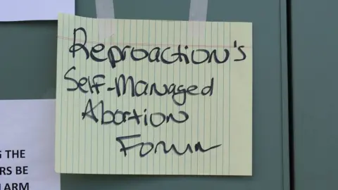 BBC A sign that reads "Reproaction's self-managed abortion forum"