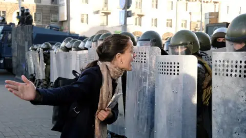 Reuters/Tut.by Protester confronting riot police in Minsk, 20 Sep 20