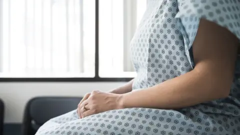 Getty Images Woman in hospital gown