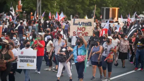 Getty Images Protesters march during a demonstration against LUMA Energy in what organizers called All of Puerto Rico Against LUMA on October 15, 2021 in San Juan, Puerto Rico.