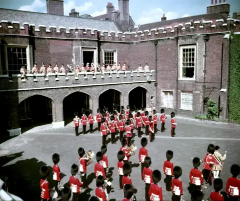 PA Media File photo dated 8/2/1952 of The Garter King of Arms, Sir George Bellew, reading the first public proclamation of the accession of Queen Elizabeth II, at Friary Court, St James's Palace