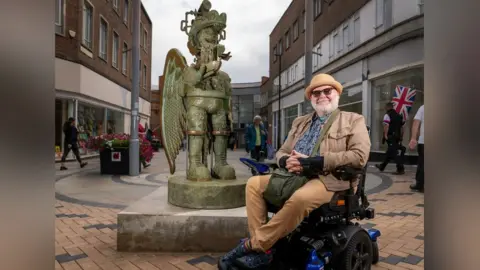 Wakefield Council/LDRS Jason Wilsher-Mills with his statue of an Amazonian love god