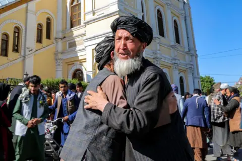 Samiullah Popal / EPA-EFE People greet each other after Eid al-Fitr prayers in Kabul, Afghanistan