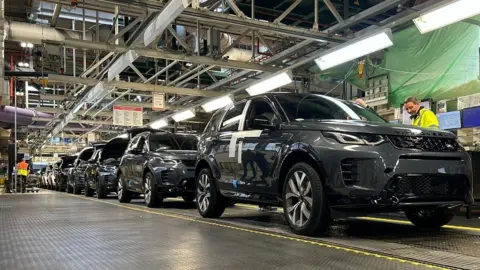 Black cars on a production line in the Halewood factory