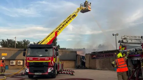 Brandon Fire Station A firefighter on an aerial ladder platform hosing down the fire