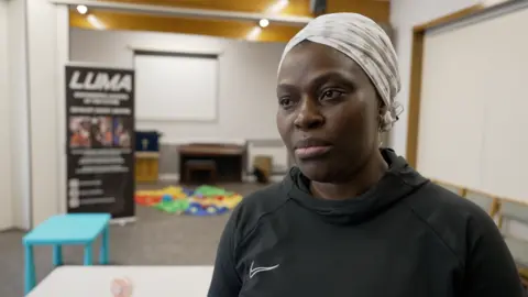 Dawid Wojtowicz/BBC Oluyinka, who is wearing a black top