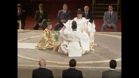 Men take part in a Shinto ring ceremony.