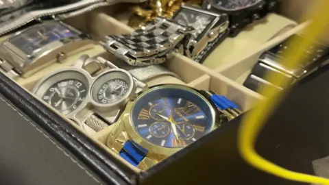 A box filled with watches.