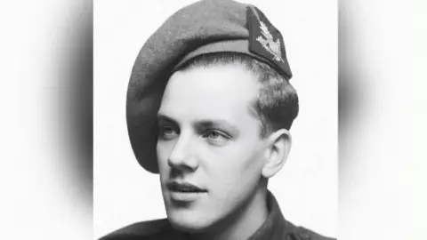 A black and white photo of Pte Milward. He is wearing his army uniform and is looking to the left of the camera. 
