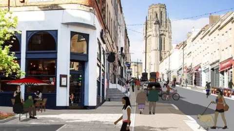 Bristol City Council An artist's impression of what Park Street could look like. It shows the corner of a restaurant with outdoor seating, people walking across the road and wider pavements. The Wills Memorial Building is visible in the background at the top of the hill.