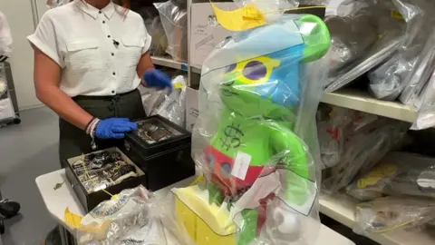 Haul of goods including large figurine and watches.
