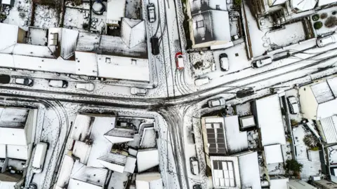 PA Media Residential streets in Dowlais, near Merthyr Tydfil, Wales, taken from a drone camera after Storm Goretti leaves a blanket of snow