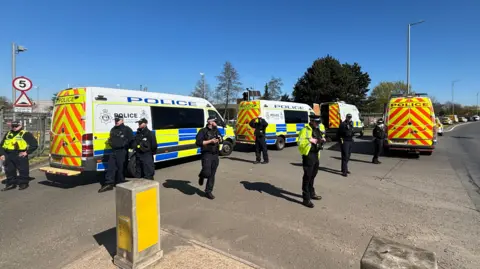Luke Deal/BBC Four police vans and several police officers stationed outside RAF Lakenheath.