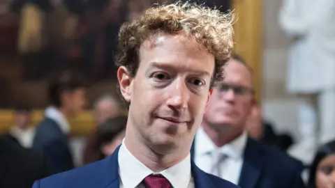 Mark Zuckerberg, Meta's co-founder and chief executive, in a blue suit and red tie.