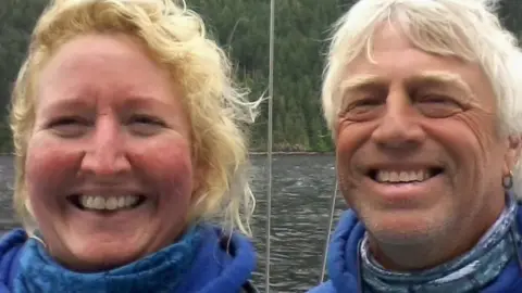 Facebook Sarah Packwood on the right, and her husband Brett Clibbery smile at the camera for a selfie