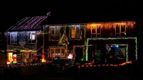 DMPhotographyNI A row of terrace house with coloured Christmas lights on them 